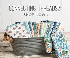 a bucket filled with lots of different colored fabrics and the words connecting threads shop now