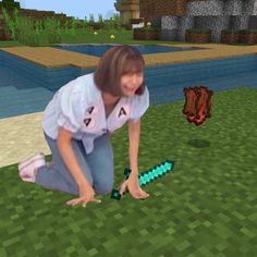 a woman kneeling down to pick up a green alligator from the ground in minecraft