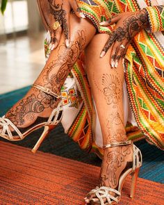 a woman's legs with tattoos and high heels