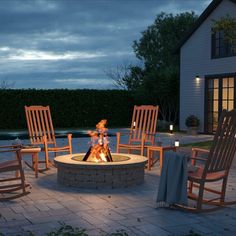 a fire pit with rocking chairs around it