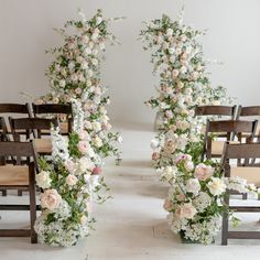 two rows of wooden chairs with flowers on them