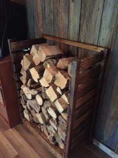 a pile of wood sitting in front of a wooden wall