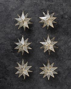 six gold star ornaments on a black surface