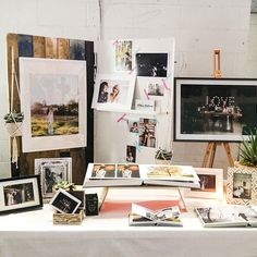 a table topped with pictures and framed photos