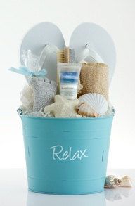 a blue bucket filled with lots of different items next to a starfish and seashell