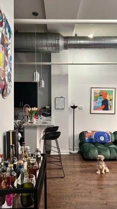 a living room filled with furniture and lots of clutter on top of a hard wood floor