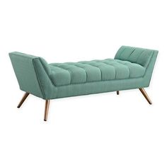 a green chaise lounge with wooden legs