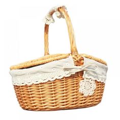 a wicker basket with white lace on the top and bottom, sitting against a white background