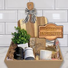 a wooden sign that says laser engraving is in a box filled with coffee mugs