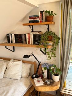 a bed room with a neatly made bed and two shelves on the wall above it