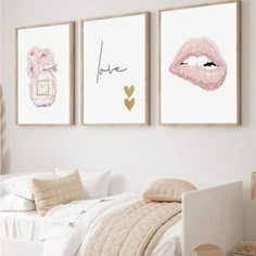 three paintings on the wall above a bed in a room with white walls and pillows