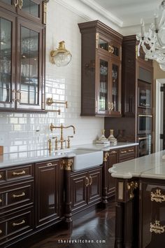 a large kitchen with wooden cabinets and marble counter tops, chandelier above the sink