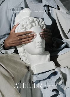 a person holding a white head in their hands