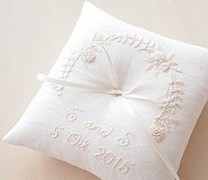 a white pillow with a ribbon tied around it