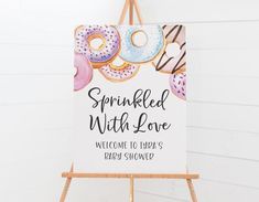 a sign with donuts on it that says sprinkled with love welcome to today's doughnut shop