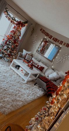 the living room is decorated for christmas with red, white and silver decorations on the walls