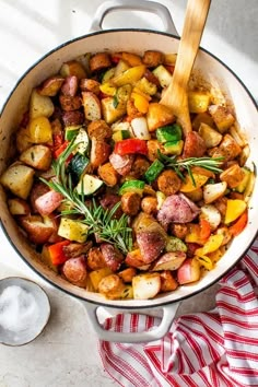 a pot filled with potatoes and vegetables on top of a table