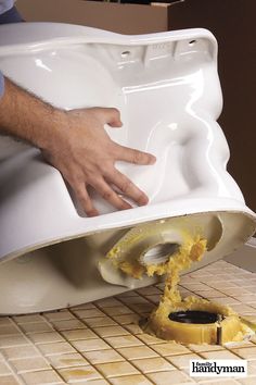 a man is using a toilet bowl to clean it