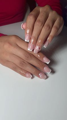 a woman's hands with french manies and pink nail polish on her nails