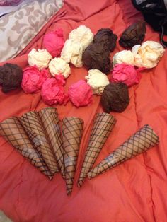 there are many ice cream cones on the bed