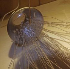 a close up of an object on a table with wires attached to the top of it