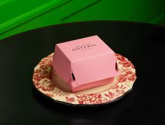 a pink box sitting on top of a plate