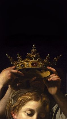 a woman holding a crown over her head