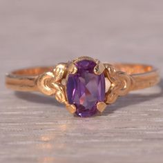 This Stunning Piece, Known As The Regal Amethyst, Features A Captivating Oval-Cut Amethyst At Its Center, Exuding A Rich Purple Hue. The Amethyst Is Elegantly Set In A 14 Karat Gold Band With Intricate Detailing That Enhances Its Regal Appearance. This Exquisite Ring Is Currently A Finger Size 4.5 Yet Can Be Adjusted To Any Finger Size For An Additional Charge Upon Request, Ensuring A Perfect Fit. Lavender Wedding Ring, Vintage Amethyst Ring, Amethyst Ring Vintage, Yellow Gold Color, Purple Rings, Rich Purple, Unusual Jewelry, Amethyst Jewelry, Purple Hues