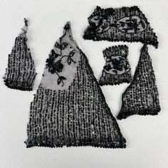 several pieces of black and white fabric with flowers on them, including one piece of lace