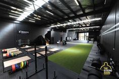 an indoor gym with green carpet and black walls