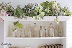 flowers and books are sitting on a shelf