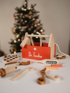 a table topped with wooden toys and a christmas tree