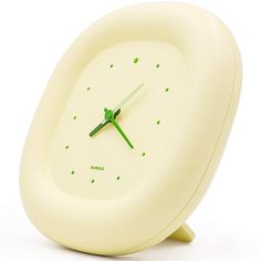 a white clock with green hands and numbers on the face is sitting in front of a white background