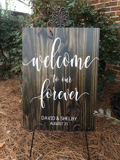 a wooden sign with the words welcome to our forever on it in front of some grass