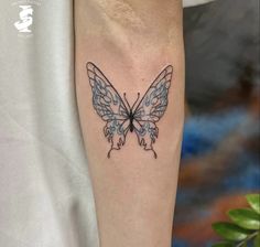 a small butterfly tattoo on the arm