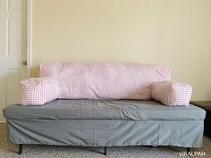 a couch with two pillows sitting on top of it