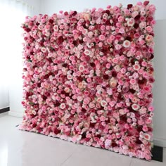 a wall made out of pink and white flowers