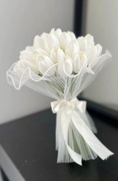 a bouquet of white flowers sitting on top of a table