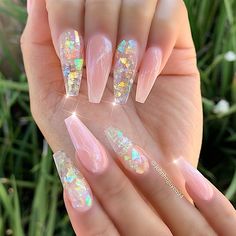 a woman's hand with some pink and white nails