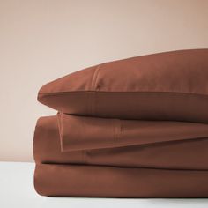 the sheets and pillowcases are folded neatly on top of each other in brown