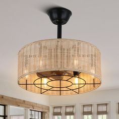 a light fixture in a living room with windows