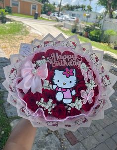 someone holding a hello kitty bouquet in their hand