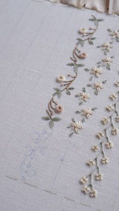 embroidered flowers and vines on white linen