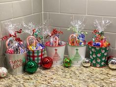 several buckets filled with candy and candies on a counter