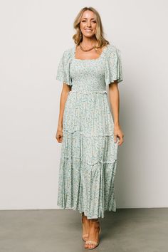 A perfect blend of style and comfort for your summer days. This daisy dress will have everyone swooning! Floral Summer Dress Long, Mormon Dress, Modest Fashion Christian, Blue Green Background, Sunday Dresses, Lady Outfit, Smocked Maxi Dress, Teacher Dresses, Sage Green Dress