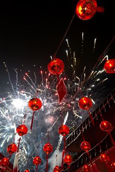 red lanterns hanging from strings with fireworks in the background royalty images, stock photos and illustrations