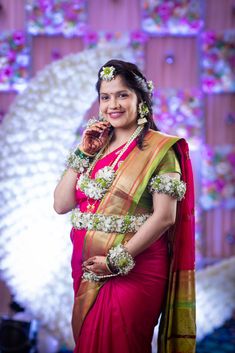 a woman in a red sari posing for the camera