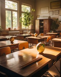 an empty classroom with wooden desks and globe on the table in front of large windows