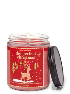 the perfect christmas candle is in a glass jar with a lid and an antler on it