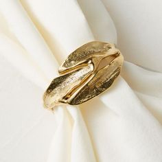 a gold ring sitting on top of a white cloth